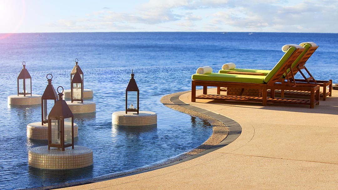 Lounge chairs by an infinity pool
